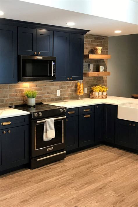 blue cabinets with black stainless steel appliances|blue counter with white countertop.